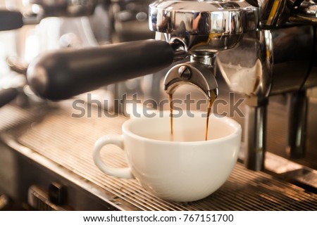 coffee extraction from professional coffee machine  Royalty-Free Stock Photo #767151700
