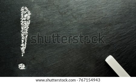 Exclamation mark written on black slate with white chalk