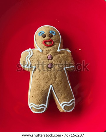 Gingerbread man over the red background. Christmas mood