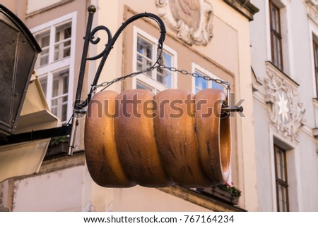 Hanging Sign Advertising Trdlo, also known as Trdelníks, traditional pastry dessert of Prague, Czech Republic.