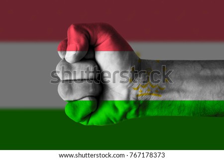 Fist painted in colors of Tajikistan  flag, fist flag, country of Tajikistan 