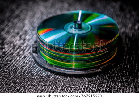 pile of compact discs on dark background
