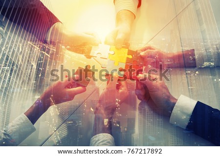Teamwork of partners. Concept of integration and startup with puzzle pieces. double exposure Royalty-Free Stock Photo #767217892