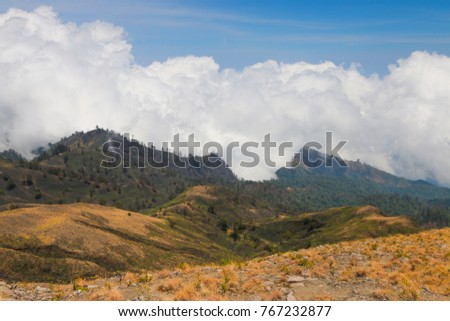 View of Mount Rinjani in Lombok Indonesia. Visible big clouds in the background.