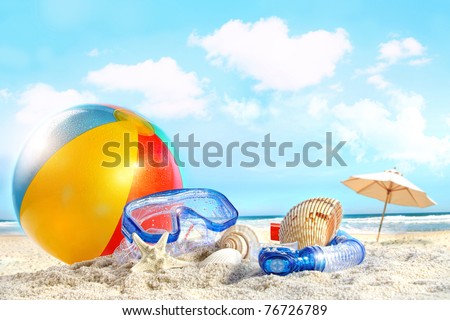 Fun day at the beach with goggles and beach ball Royalty-Free Stock Photo #76726789