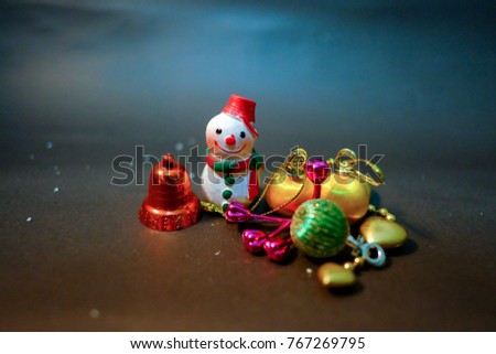 Snowman and ornaments with christmas decoration on dark blue background and warm night light