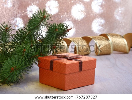 Christmas decoration with gift boxes and christmas tree on a blurry, sparkling and fabulous background.
