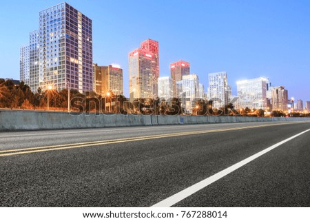 Asphalt highway and modern business district office buildings in Beijing at night,China