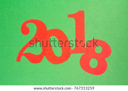 New Year background. 2018 cut out red paper numbers on green.