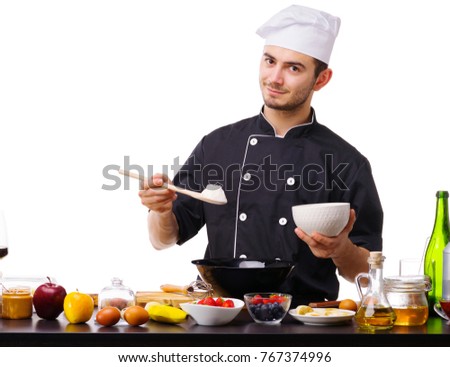 Close-up of a guy's hand, the chef, put a wooden spoon of flour in a black plate