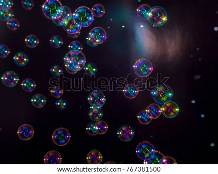 blur soap bubbles colourful floating on air .at black background.