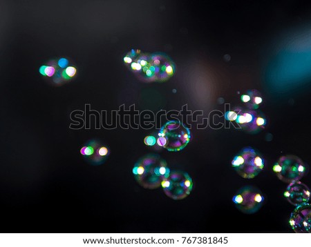 blur soap bubbles colourful floating on air .at black background.