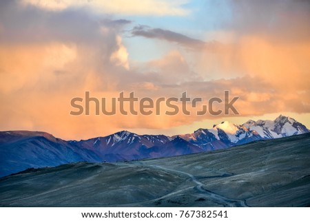 Sunset scene on the top of Himalayas and road in foreground, tso Moriri, Ladakh, India