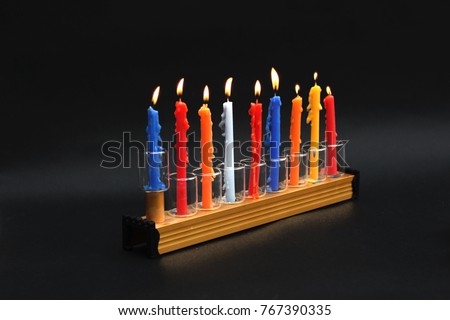 Hanukkah menorah with colored lighting candles