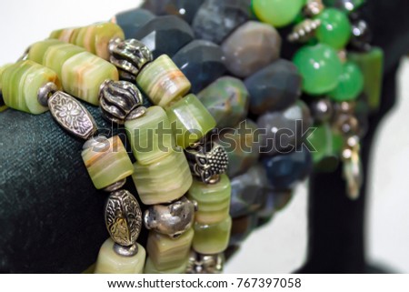 Women's bracelets from semiprecious stones. Showcase in the shop Royalty-Free Stock Photo #767397058