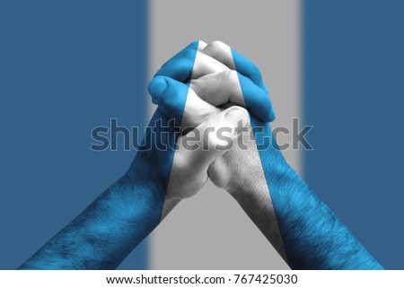 Clasped hands patterned with the Guatemala flag, multi purpose concept - isolated on flag background