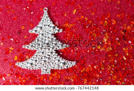 Silver Christmas tree on shiny red background