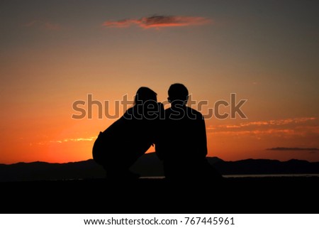 Silhouette of a couple loving each other -at sea side