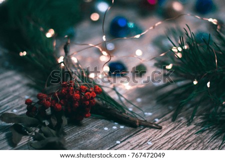 Christmas decorations on a wooden background with branches of a Christmas tree