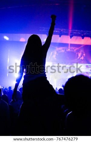 Crowd enjoying concert, happy people jumping, large group celebrating new year holiday, party background fun concept