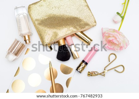 Cosmetics for make-up of gold color on a white background. Flat lay