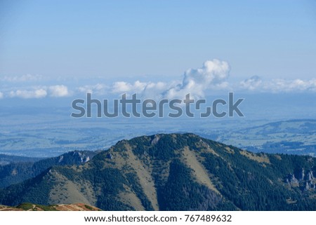 western carpathian mountain tops in  autumn covered in mist or clouds. panoramic view from a distance