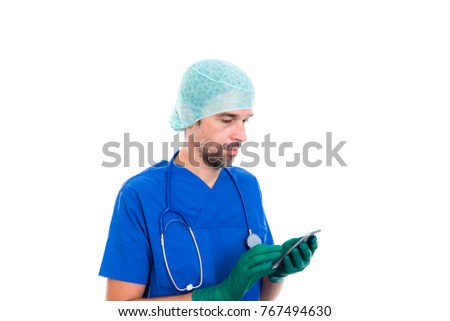 young doctor with cellphone in front of white background
