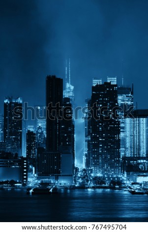 Manhattan midtown skyscrapers and New York City skyline at night with fog