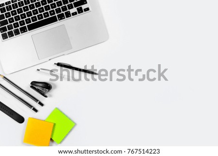 Working table top view, flat lay. Business items on a white table, laptop, clock, phone, pens, stickers. Copy Space, Concept of business attributes.