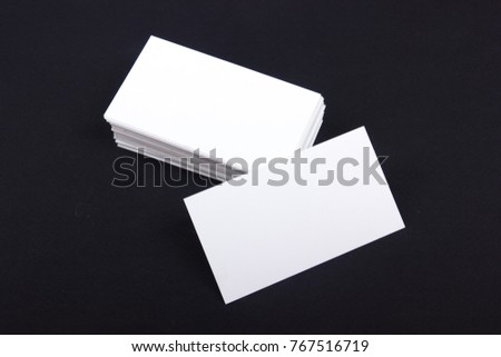 Blank business cards at black textured background.. Template for ID. Top view