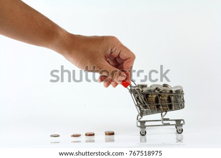 Full of coin in the cart with the hand to push it isolated on white background, in concept of money saving, business and finance, money currency