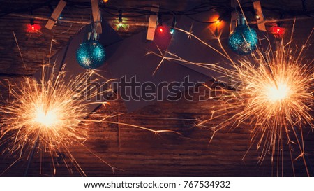 New Year's, Christmas background with Christmas sparklers and Christmas-tree toys. Copy space. Holidays. Greeting card.