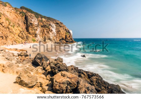 Dume Cove Malibu, Zuma Beach, emerald and blue water in a quite paradise beach surrounded by cliffs. Dume Cove, Malibu, California, CA, USA Royalty-Free Stock Photo #767573566
