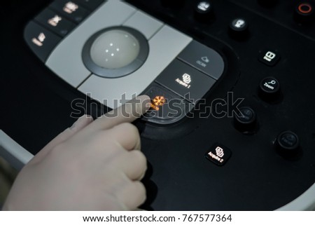 Doctor hand pressing on control panel button of ultrasound machine, Medical equipment concept