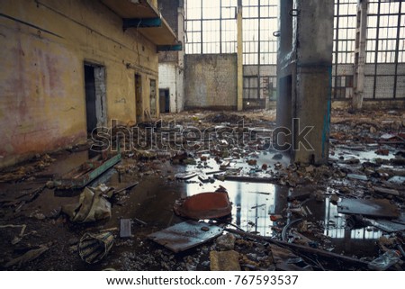 Ruined industrial building with puddles on the ground creepy abandoned warehouse, toned