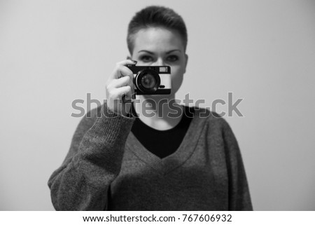 Photographer and her lovely photo film camera. Love photography. Black and white photo
