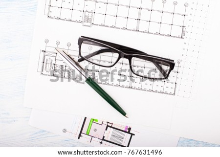 Architectural project and  glasses. Construction background.