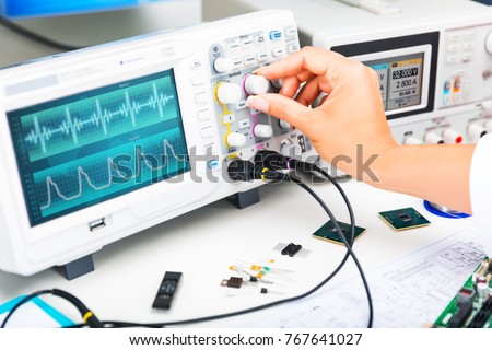 Digital oscilloscope is used by an experienced electronic engineer in the laboratory Royalty-Free Stock Photo #767641027