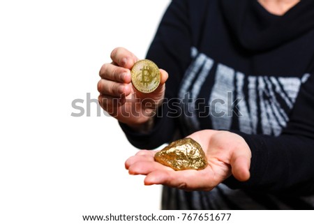 Gold nuggets with a bitcoin in the hands of the miner mining golden bitcoins