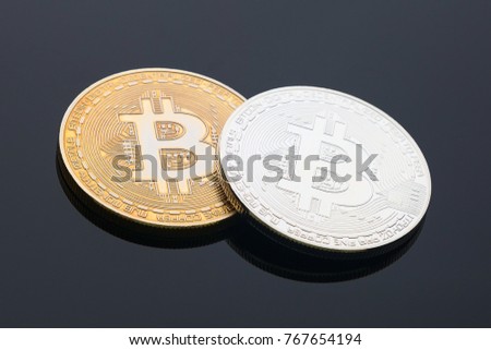 Golden and silver bitcoin on black background, cryptocurrency image, copy space