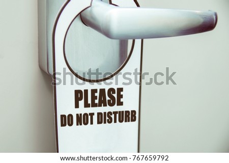 Door handle with door sign "please do not disturb" in a hotel