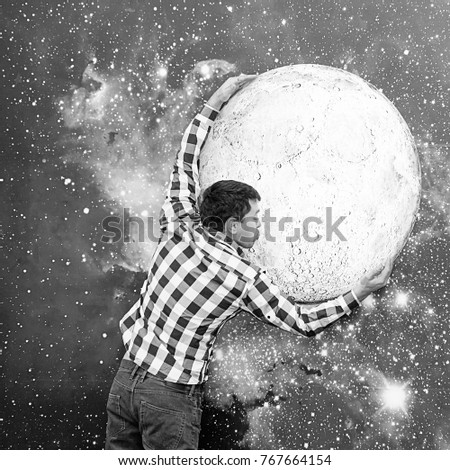 Portrait of a man on a space background. Young man on the background of moon sky. Boy kiss the moon. Black and white photography