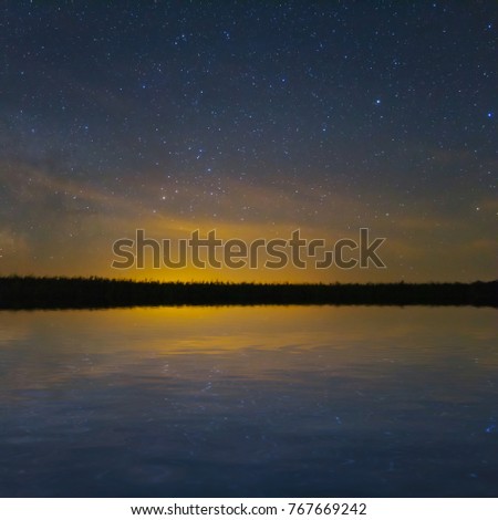 night sky reflected in a quiet lake