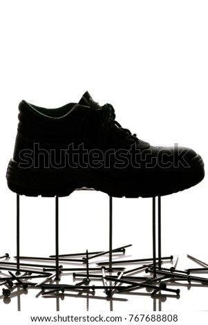 silhouette of protective boots, special protective footwear with firm sole for construction standing on nails and self-tapping screws on white isolated background, concept safety in work