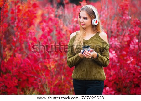 Young woman with music player. Woman in black hat