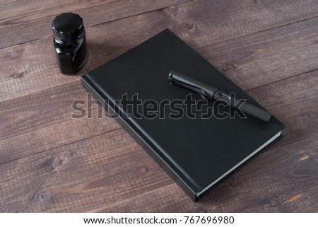 Fountain Pen, Notebook, Ink on wooden table