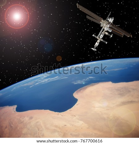 Spacecraft and the earth. The elements of this image furnished y NASA.
