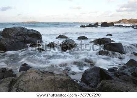 
the water that crashes into the huge rocks of the sea