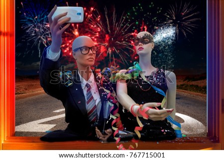 pair of mannequins takes a selfie celebrating New Year's Eve in the street under the fireworks