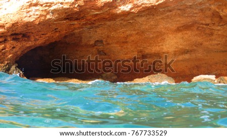 Sea level photo of cave in stormy morning with huge waves, Greece